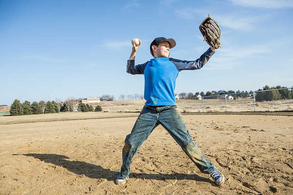 Boy pitching a baseball