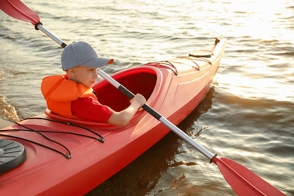 Boy paddling in kayak