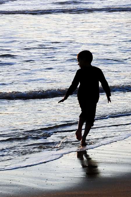 Boy running on seashore