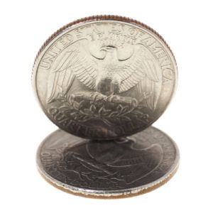 One coin balanced upright on another coin