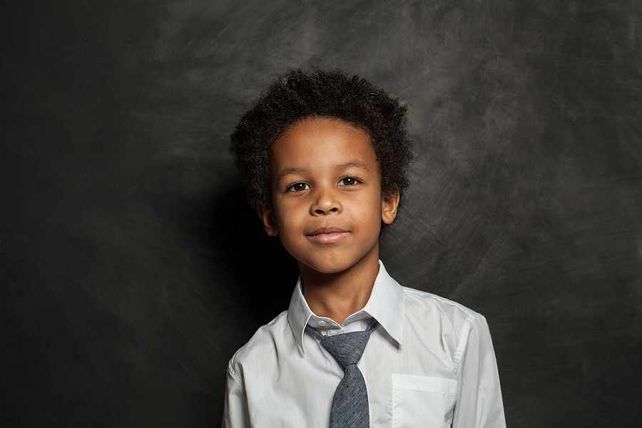 Boy standing in front of a chaklboard