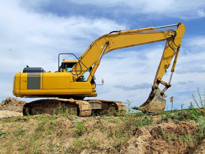 Excavator on muddy bank