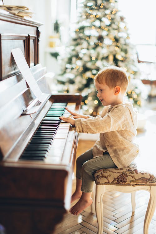 Young boy sitting at piano
