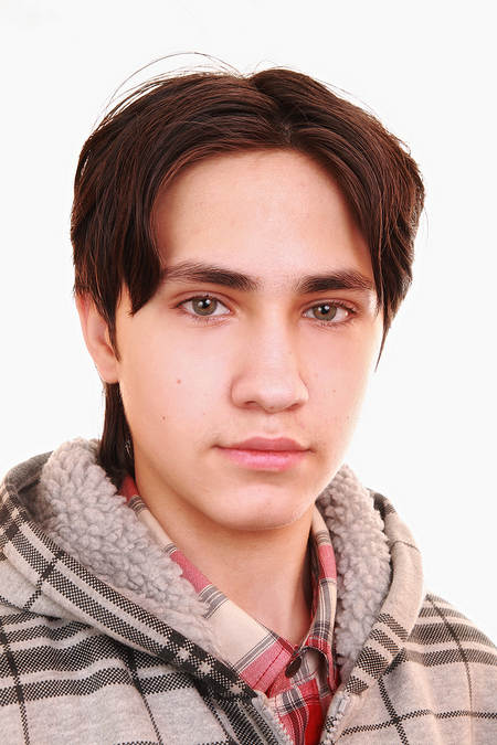 Bust of pensive teenage boy looking at camera