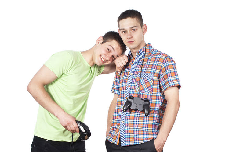 Two teen boys with games controllers