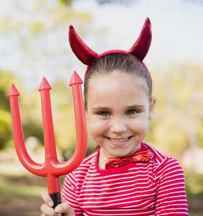 Young girl pretending to be a devil
