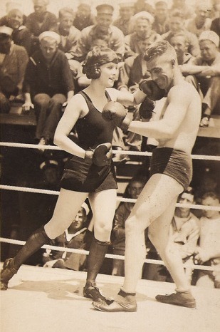 Young woman and young man boxing