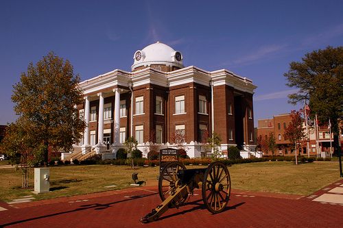 Cannon with courthouse in the background