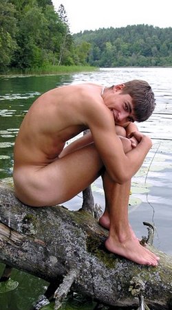 Young man sitting on a log, naked