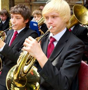 Teenage boy playing a French horn
