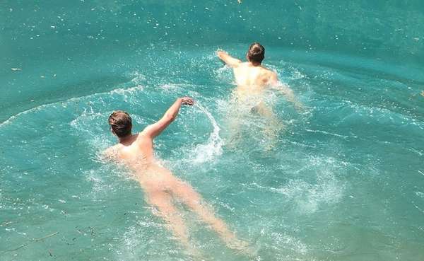 Two men swimming