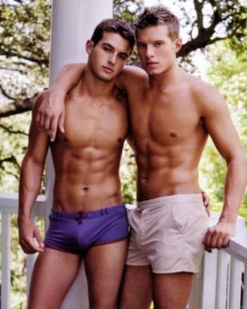 Two young men in shorts with their arms around each other