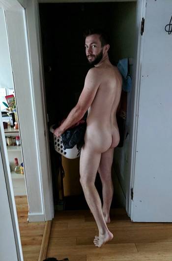 Young man carrying laundry basket