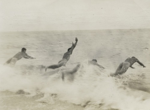Men diving into the ocean