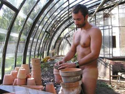 Man filling a plant pot with soil