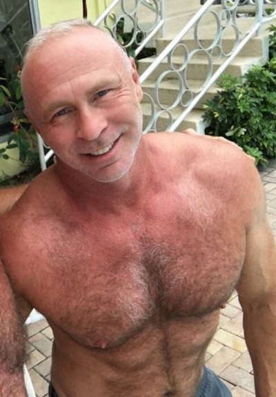 Shirtless middle-aged man