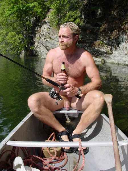 Nude man fishing from a rowboat