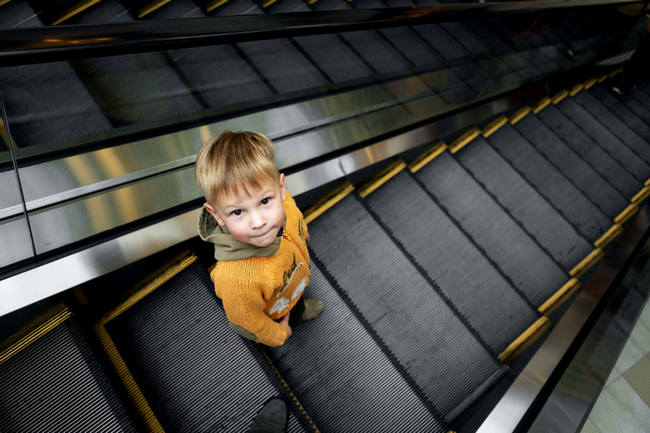 Young boy on escalator