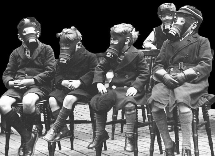 Young boys wearing gas masks