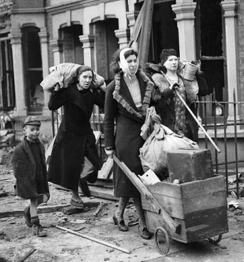Three women and a young boy moving their meagre possessions