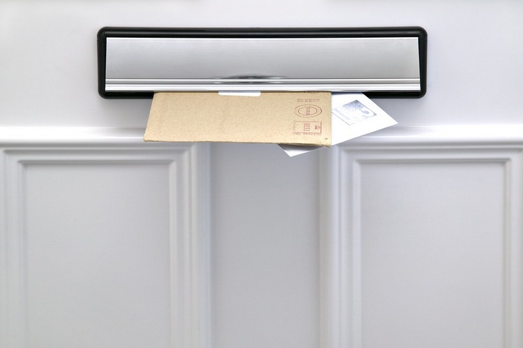 Letters sticking out of letterbox in door
