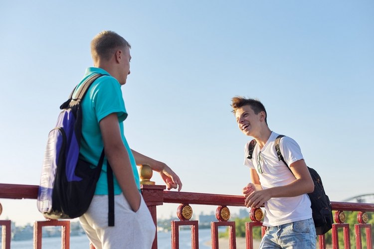 Two smiling teen boys chatting