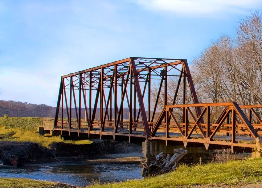 Steel-truss bridge over a stream