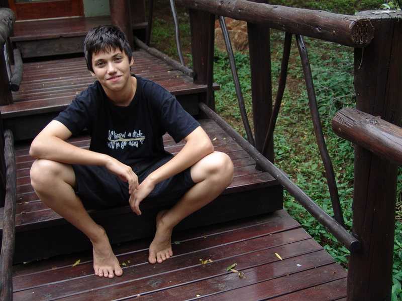 Boy sitting on steps smiling