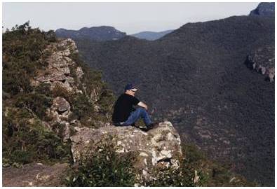 Man sitting on rock outcrop